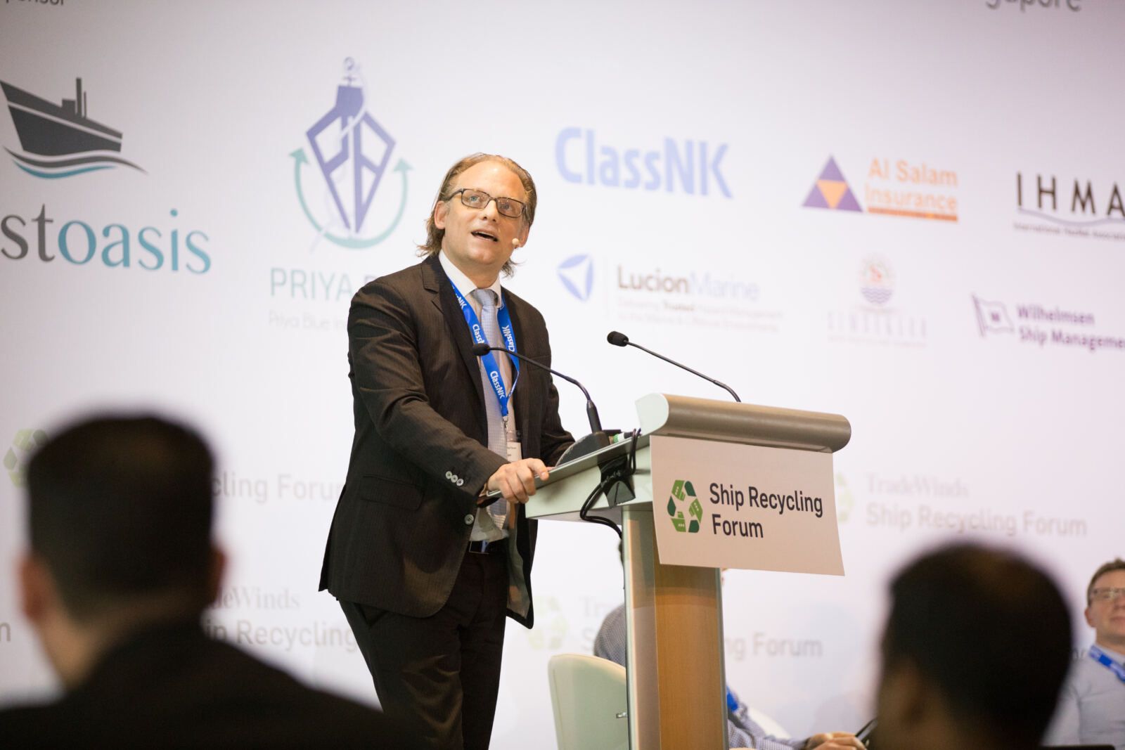 Keynote speaker addressing a full room at an industry forum
