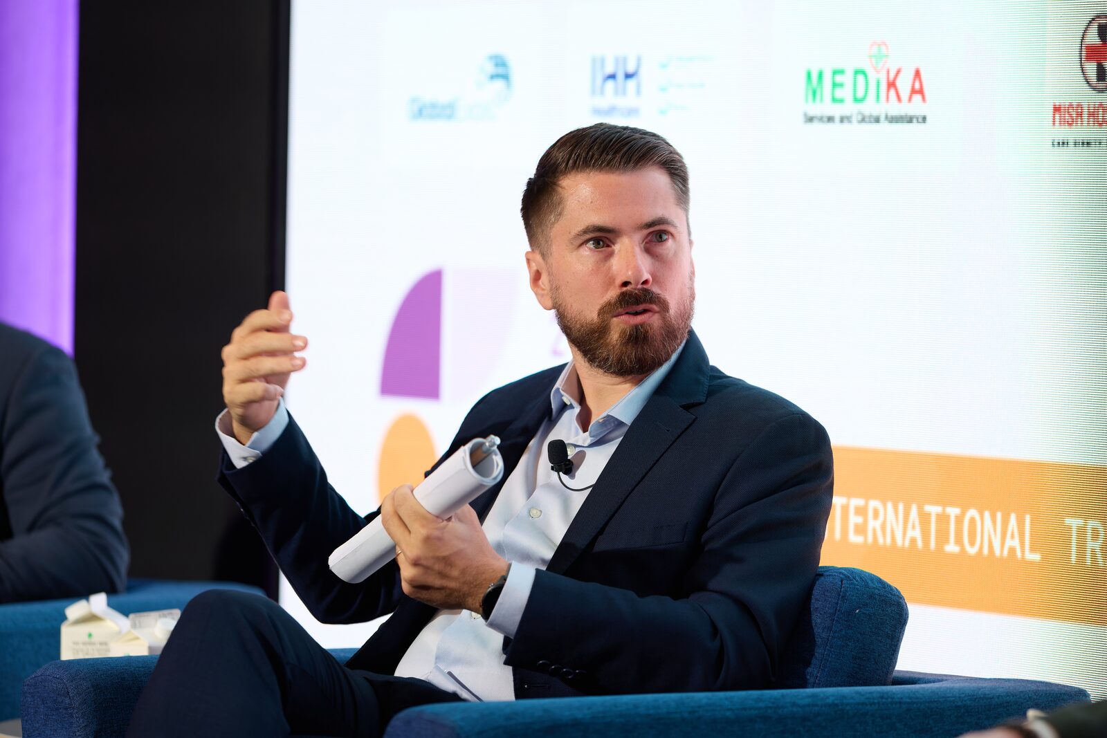 Panellist speaking during a seated stage discussion