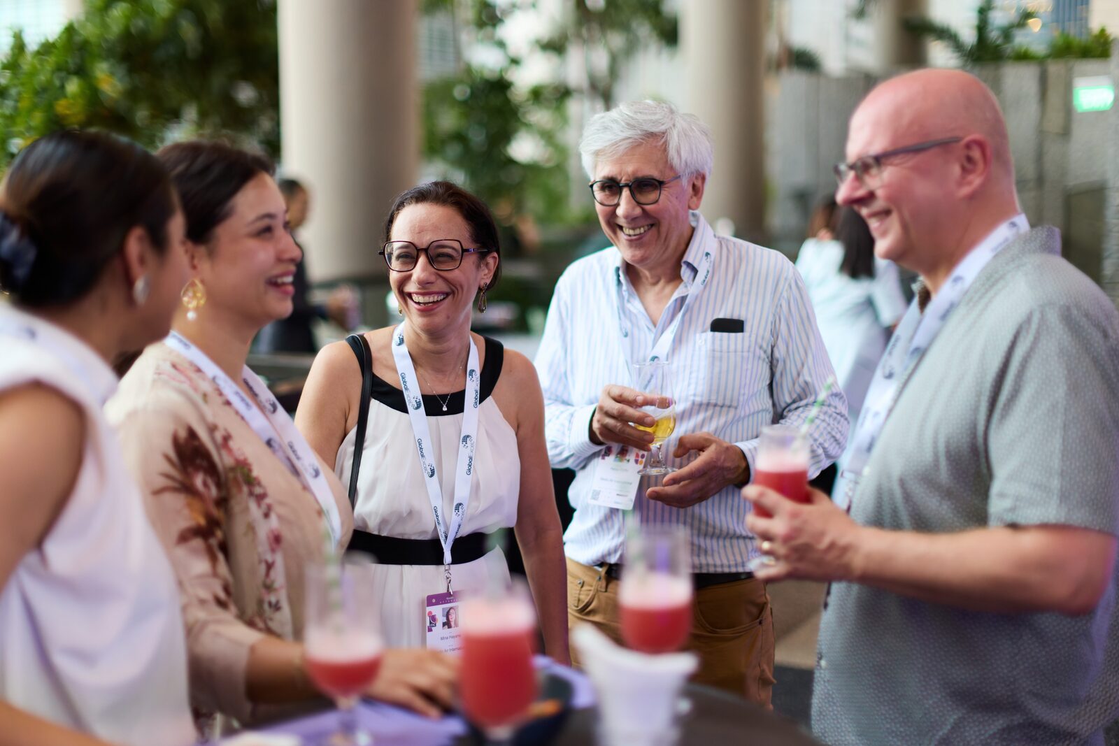 Delegates in conversation over drinks at an evening reception