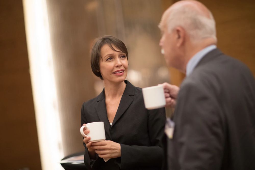 Two delegates talking over coffee