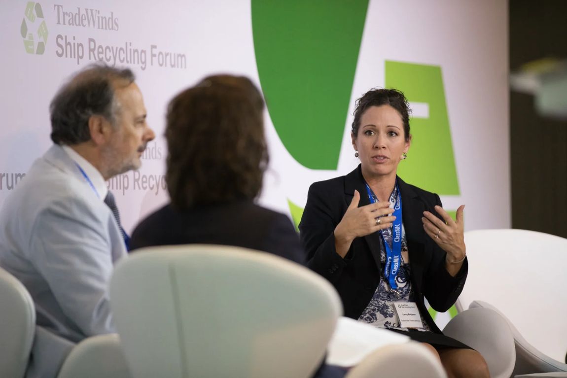 Panellist making a point during a seated discussion