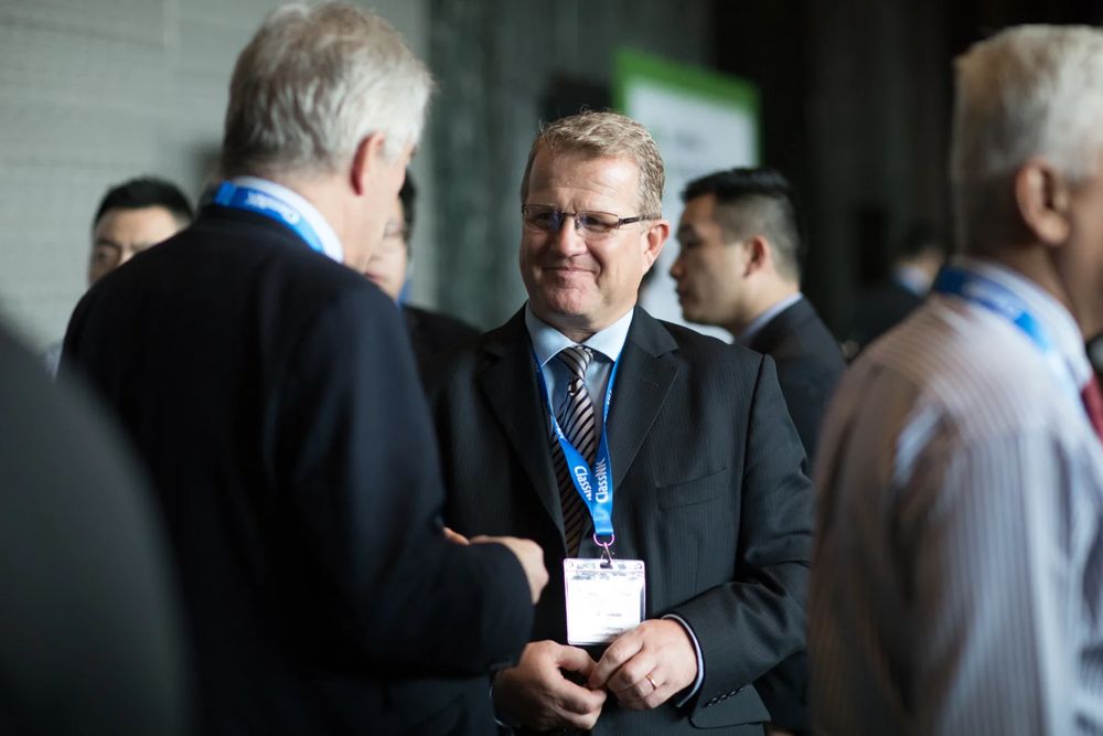 A delegate sharing a laugh at a reception